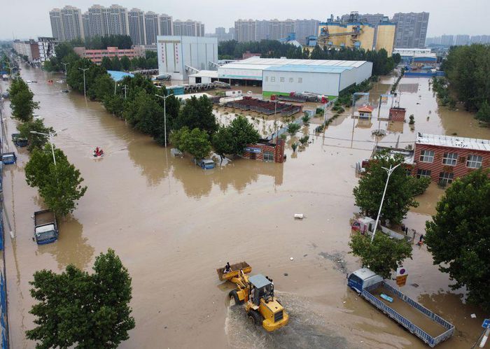 các nhân viên cứu hộ đang sơ tán cư dân trên con đường ngập lụt sau trận mưa lớn ở Trịnh Châu, tỉnh Hà Nam, Trung Quốc ngày 22/7/2021.